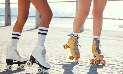 Image showing Roller skates or fun friends on promenade for summer holiday activity or travel outdoor. Cool, trendy or funky women skating legs in quad skating or rollerblades with sunshine, beach and ground