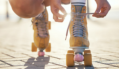 Image showing Yellow roller skates shoes of woman in summer outdoor travel, journey or fun activity for the holiday. Cool, trendy or funky gen z person prepare or tie laces on ground in quad skating with sunshine