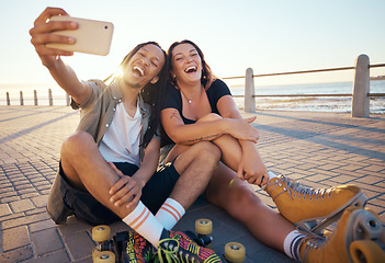 Image showing Selfie of young skater friends with phone smile and laugh at the beach. Cool cheerful man and woman smiling and having fun on the weekend. Happy couple with rollerskate having fun together outside