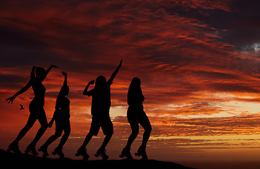 Image showing Sunset, silhouette and roller skate friends out on an adventure or travel for fun while skating and watching horizon view with orange or red sky. Freedom, scenery and beauty of nature and friendship
