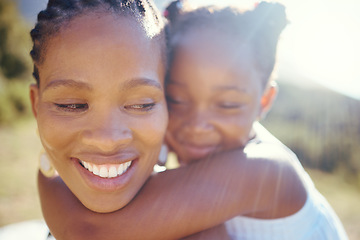 Image showing Happy black mother and playful daughter having fun together in the sun. Carefree woman carrying excited girl for a back ride while bonding outside. Single mom enjoying quality family time with kid