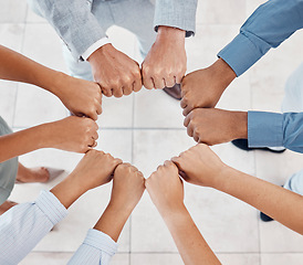 Image showing Fist of diversity business team work together in partnership, collaboration and teamwork top view. Hands of business people at support, team building and strategy meeting for corporate global success