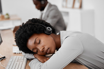 Image showing Call center, burnout and sleep of a woman employee resting on a desk at the office. Exhausted black female telemarketing agent or consultant in customer support or service sleeping on the job at work