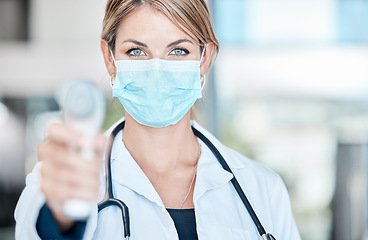Image showing Doctor, covid and mask of a woman with thermometer pointing to check patient health status at a hospital. Medical, healthcare and clinic female worker with a scanner testing people for virus or fever