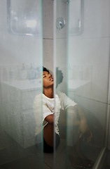 Image showing Mental health, anxiety and depression by sad woman sitting on floor the of a shower, stress and afraid. Young female suffering from a panic attack, fear or phobia while looking exhausted and anxious