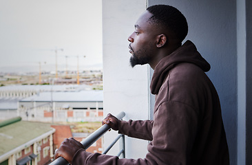 Image showing Depressed, sad and thinking man with mental health problem on balcony, planning idea while in apartment with anxiety and burnout from depression. Fail, decision and African person think at house