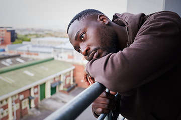 Image showing Sad, tired and depressed man on balcony of apartment, thinking of mental health in house and anxiety from problem at home. Face of African person with depression and burnout thinking of idea