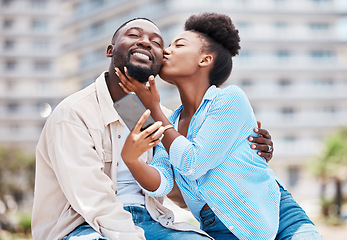 Image showing Love, kiss and couple take phone selfie on romantic date together, happy and smile while relax outdoors on summer holiday. Black woman and man on a romance travel adventure or journey in urban city