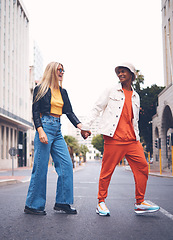 Image showing Happy interracial couple with fashion clothing in a urban city street with a smile and love. Trendy, stylish or punk man and woman walking in a town road with funky, edgy and style together