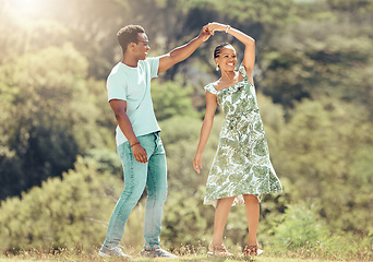 Image showing Love, freedom and celebration by couple dancing outdoors, loving romantic getaway and bonding. Happy black man and woman being playful and sweet, enjoying their relationship and having fun together