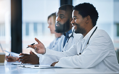 Image showing Doctor have discussion about medical document in a meeting together at work. Healthcare workers talking and planning, communication and strategy in a hospital office or boardroom