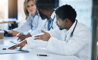 Image showing Healthcare, diversity and a medical conference, male doctor in discussion or meeting with team. Teamwork, collaboration and communication, health care workers talking and planning at hospital office.