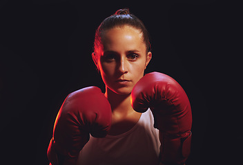 Image showing Boxing feminist, fitness and sport with strong woman wearing boxing gloves for mma fight, fitness and empower with black background. Fit boxer female and champion attitude for self defense and power