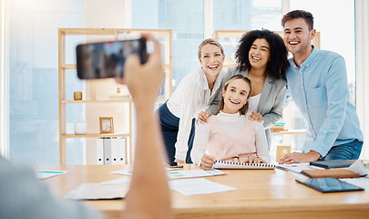 Image showing Creative, business and corporate team taking a picture on a phone in the company conference room. Happy employees in a meeting consulting and planning a project. Work friends having fun at the office