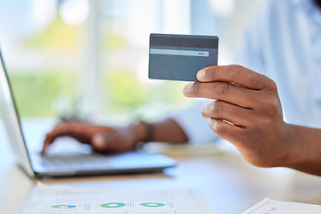 Image showing Man has credit card in hand, for online shopping or payment of bills via app on his laptop. Male customer at table has card for banking information, to pay on ecommerce store or website on computer.