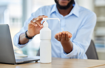 Image showing Covid, hand sanitizer or black businessman with laptop cleaning bacteria, virus or stop to global healthcare crisis. Zoom on hands, security or safety in company office by research employee or worker