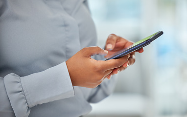 Image showing Phone, hands and communication with a business woman networking with wifi technology in her office at work. Closeup of a female employee reading, typing or sending a text message on her mobile