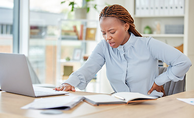 Image showing Business black woman, back pain and health stress, risk and muscle injury at modern office workplace desk job. Young african american, uncomfortable spine problem and bad sitting posture for working