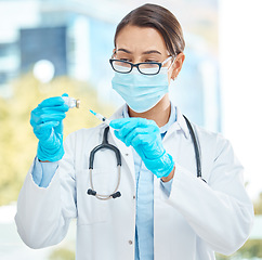 Image showing Medical, healthcare and covid vaccine by woman doctor working during corona pandemic in a hospital. Young health care worker holding medical innovation, confident while prepare cure injection