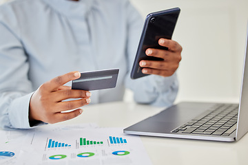 Image showing Finance, accounting and trading with a businessperson using a phone and credit card in her hands and a graph on the desk. Fintech, investment and banking with a female employee managing money online