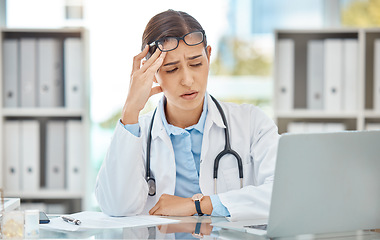 Image showing Headache stress, doctor burnout and sad nurse working on laptop in work office at hospital, tired from consulting in healthcare and anxiety from medical surgery. Worker with depression at clinic