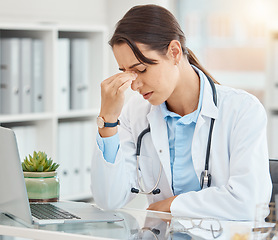 Image showing Stress, depression and tired female doctor suffering from a headache or mental health while sitting in an office with laptop. Frustrated, upset and overworked healthcare or medical worker in hospital