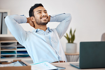 Image showing Businessman relaxing at a desk in the office at his corporate job after finishing a project. Happy, calm and stress free man employee sitting and resting at his table after a successful work day.