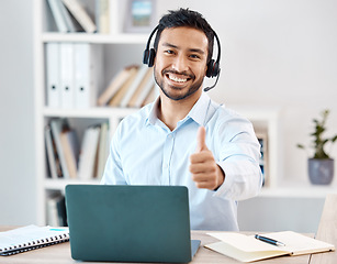 Image showing Thumbs up, customer service and call center with a man saying yes while working in telemarketing and sales. Motivation, crm and contact us with a male employee saying thank you while consulting