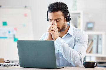 Image showing Stress, headache and depression of call center agent feeling overwhelmed, upset and frustrated while wearing headset and using laptop at desk. Male crm, telemarketing and customer support operator