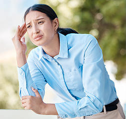 Image showing Stress, anxiety and headache by woman employee suffering with pain, unhappy and holding her head outdoors. Young corporate worker looking exhausted, experience burnout and pressure at the workplace