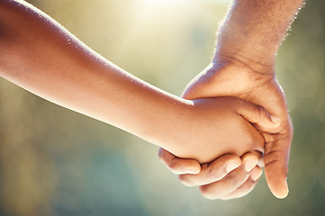 Image showing Trust, family and adoption with father and child holding hands while walking together outside. Parent and kid showing security, care and love with man and boy sharing a safe and special bond