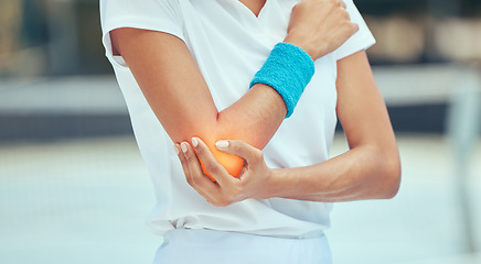Image showing Tennis elbow, pain and injury with a sports woman holding her joint during training, workout and exercise. Fitness, health and accident with a female athlete in a game or match on a court outside
