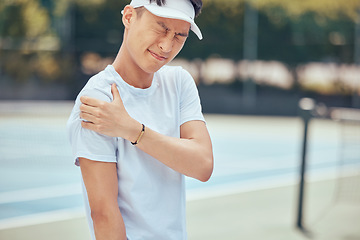 Image showing Tennis arm, man and pain on the court while playing competitive and intense game workout outside. Inflammation, accident and injury at sports training practice with asian athlete holding muscle.