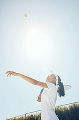 Image showing Tennis court, outdoor girl and ball in sky after professional hit with sports racket in match. Woman champion, competition and talented and fit athlete person with expert game play technique.