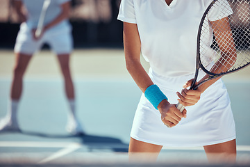 Image showing Tennis player, sports woman and teamwork on a court in wellness exercise, training and health workout for competition match or game. Hands, racket and motivation for energy fitness players with coach