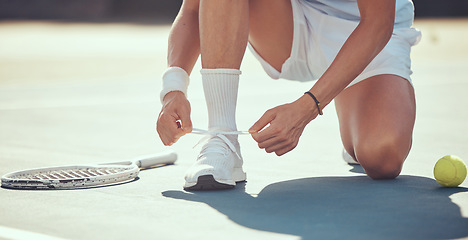 Image showing Tennis sports athlete tie shoes to prepare for exercise, fitness or competition training on tennis court. Player or man hands tying shoelaces ready for game, tournament or health performance workout