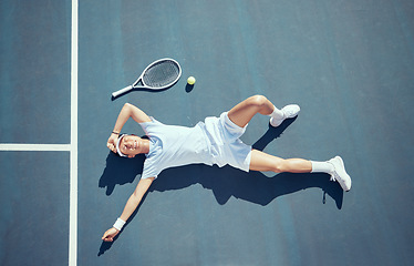Image showing Tired tennis player, sports burnout and game fatigue on court sport training, muscle injury from exercise on ground and sad about mistake. Depressed and Asian athlete upset about competition loss