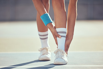 Image showing Tennis athlete with ankle injury, pain and hurt on a court after training, workout or practice outdoor. Professional sport person with accident after fitness exercise, game or match at a sports club