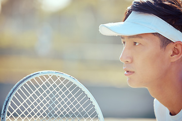 Image showing Tennis, sports and exercise focus of a Asian man athlete in a sport, training or fitness game. Player from Japan with a competitive mindset feeling healthy, strong and ready to start a workout match