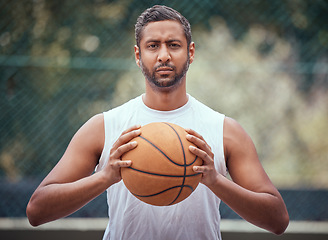 Image showing Basketball court, man and serious portrait with ball in outdoor sports venue for practice. Competitive, strong and mature athlete male thinking of a game play strategy for outside match.