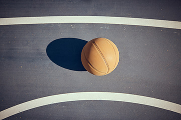 Image showing Basketball, empty game court and sports ball ready for sport exercise and health training. Top view of orange workout fitness tool for fun team sport with a light shining casting a shadow on a floor