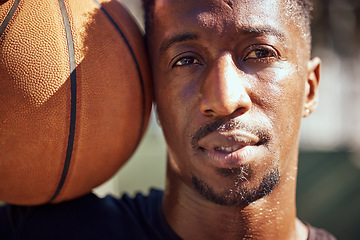 Image showing Basketball, sport and face with a man training with a ball for health, workout and fitness. Motivation, sports and exercise with a young male athlete playing a game or match on a court outside