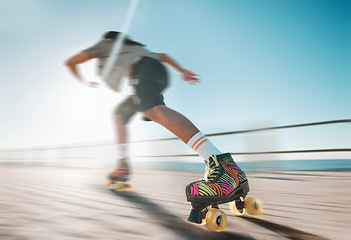 Image showing Freedom, speed and fitness, a woman on roller skates in the sun. Summer sports, retro exercise and a girl skating as a workout. Action, motion and sunshine, a professional skater going fast on a path