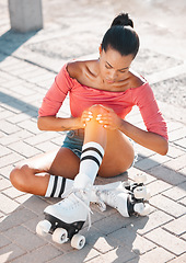 Image showing Roller skate and sports knee injury for girl hurt on the floor after travel, ride and skate on sidewalk. Emergency, accident and training woman learning to roller blade hurt on the ground after fall