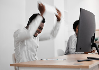 Image showing Stress, angry and frustrated African businessman working on a computer in a modern company office. Aggressive, corporate and black employee upset about broken desktop while doing an online project.