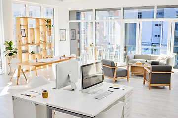 Image showing Empty office room, workplace or interior with an arranged desk, computers and furniture. Corporate organized work space, business company working area or modern headquarters workspace