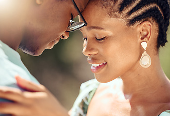 Image showing Happy couple hugging in nature while on a romantic date while bonding in the park. Closeup of care, love and young man and woman embracing each other in an outdoor garden during spring.