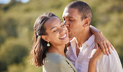 Image showing Happy black woman and man couple kiss, love and dating in relationship summer nature romance date. Hug, embrace and romantic black couple smile, kissing and happiness on vacation or holiday together