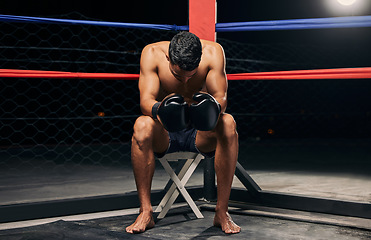Image showing Boxing ring, gloves and strong man in dark aren for fitness motivation or mma wrestling match or fighting training with light shine. Professional boxer in extreme sports for wellness, health muscles