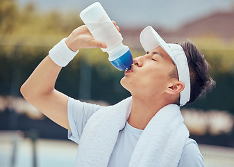 Image showing Asian man drinking water, fitness and relax after a training session, workout or exercise. Athlete, health and sports male resting with refreshing liquid after playing a sport, cardio or running.